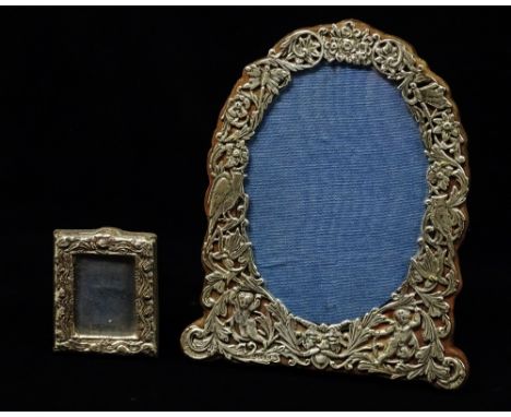 Silver Photograph Frame - A silver oval easel photograph frame, decorated with dragonflies, birds and cherubs, London 1883, m