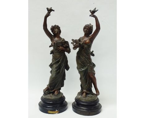 After Moreau Circa 1900 - A pair of spelter figures of ladies with doves, one holding a lyre and clarinet, the other holding 