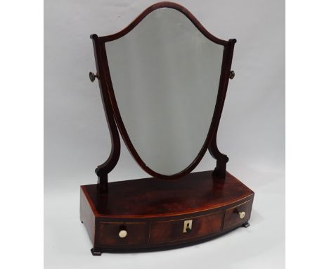 Georgian Dressing Mirror - A mahogany shield shaped mirror supported on a bow fronted satinwood crossbanded base with three b