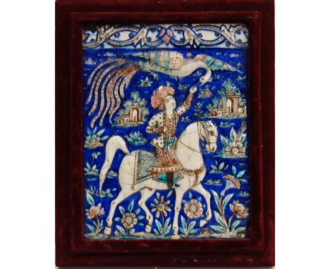 Hawking - A 19th century Persian ceramic plaque depicting a figure on horseback falconing, probably Qajar, in a burgundy velv
