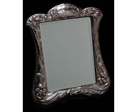 Silver Easel Mirror Etc. - A shaped silver easel dressing table mirror, embossed with daffodils and with a vacant cartouche t