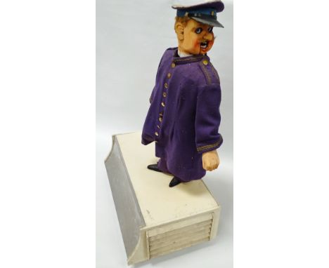 Automaton - 'The Commissionaire', a mid century felt behatted and uniformed figure, scratch built, with painted carved wood h