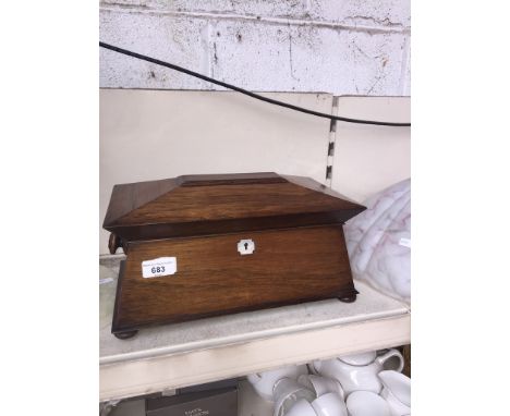 A late Regency rosewood tea caddy of sarcophagus shape and with interior boxes and glass mixing bowlCondition: minor area of 