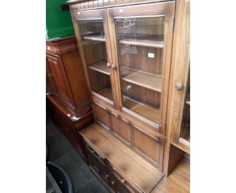 An Ercol Golden Dawn glazed top dresser with drop front drinks cabinet. 