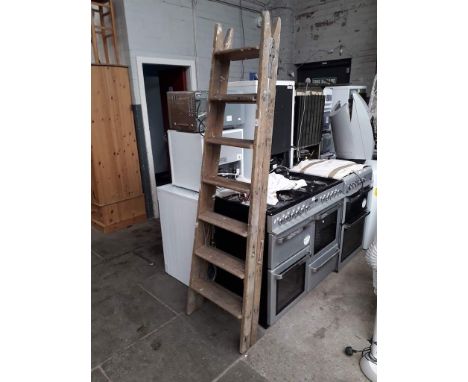 A large set of wooden step ladders 
