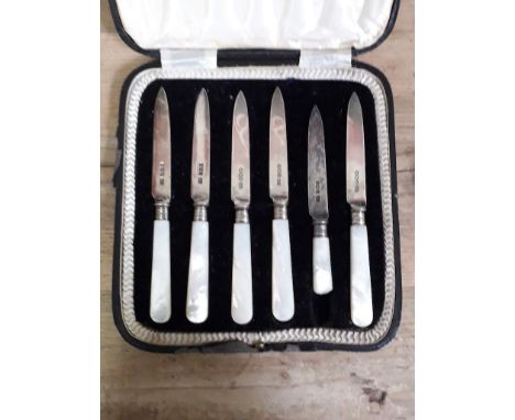 A cased set of six hallmarked silver bladed knives with mother of pearl handles, (one handle broken). 