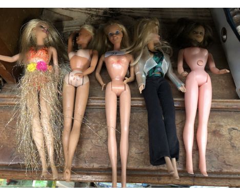Five dolls including two 1960s Mattel Barbie dolls, one 1990s Mattel Barbie doll and two others unmarked. 