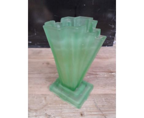 An Art Deco green pressed glass vase.Condition: crack from first step of base upwards approx 5cm, small crack to rim visible 
