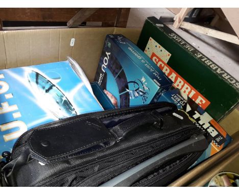 A box of games including Trivial Pursuit, Scrabble, a lap top carry case and a UFO flash lamp 