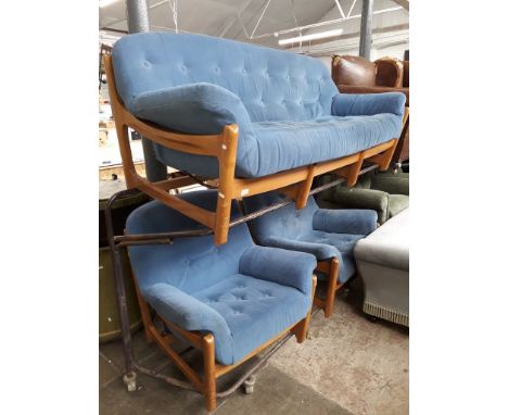 A mid 20th century elm framed three piece suite with blue coloured cushions, comprising a three seater settee with a pair of 