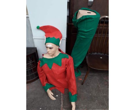 A mannequin on stand/base dressed in elf costume 