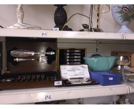 A canteen containing fish service set, two sets of mother of pearl handled knives and forks, some stainless steel pieces, and
