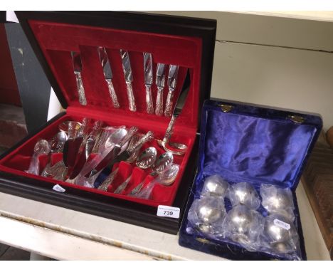 A canteen of Osborne silver plated and stainless steel kings pattern cutlery and a cased set of plated egg cups 