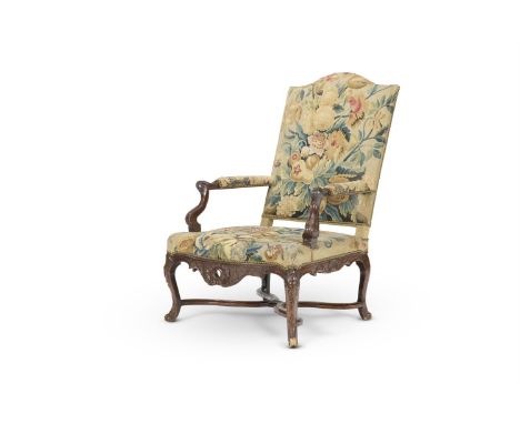 A REGENCE BEECH FAUTEUIL FRENCH, EARLY 18TH CENTURY  The back and seat with 18th century floral needlework, the upholstery on