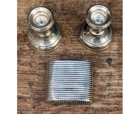 A silver powder or snuff box with hinged lid, ribbed pattern, pocket shaped, weighing approx 2.28 ozt, indistinct hallmark, w