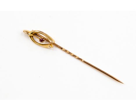 A 9ct gold stick pin with finial wish bone shape, and ruby