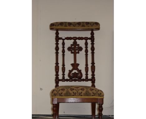 A Victorian walnut bobbin turned prie-dieu chair, upholstered back rest, upholstered seat