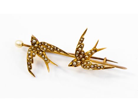 A yellow metal ladies bar brooch (probably 14ct) with two 'swallows in flight'' both set with seed pearls and a pearl finial,