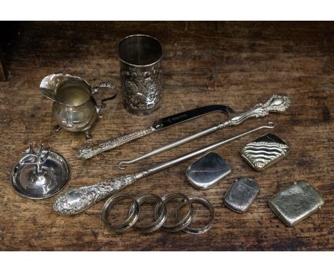 A silver cream jug, Chester, together with four silver napkin rings, Birmingham, a sliver vase cover with cherub decoration, 