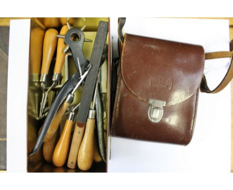 A tin of leather working tools, together with, a leather cased pair of binoculars, Carl Zeiss lenses