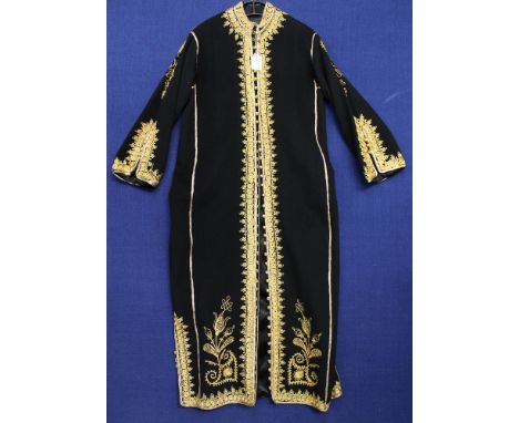 A 1960s woolen kaftan, black coat with intricate gold thread, looped button holes and gold thread buttons on the decorative c