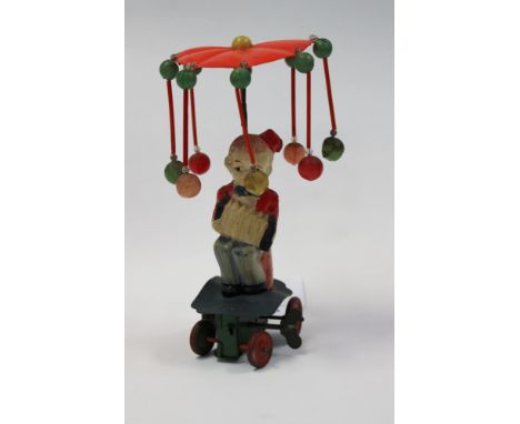 A Japanese clockwork toy of a seated accordion player, with key, working order
