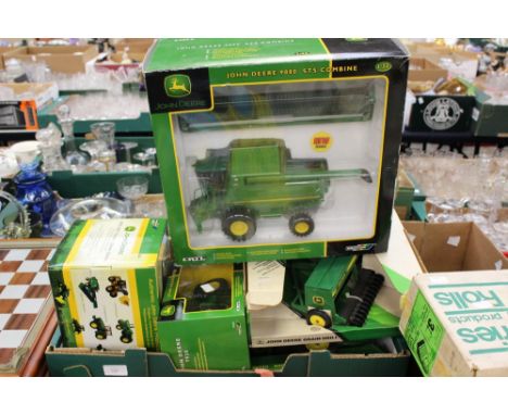 A quantity of boxed ERTL and Britain's John Deer 1/32 scale tractors and farm machinery, with a larger scale tractor and trai