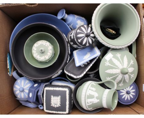 A collection of Wedgwood Jasperware to include a lidded urn, jugs and bowls on green ground, a bowl, trinket boxes and vase o