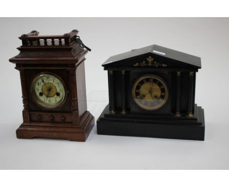 A Victorian slate mantle clock with four pillars to front and Roman numerals to dial; together with a German oak cased bracke