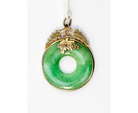 A jadeite donut ring style pendant with yellow metal surround in the form of leaves, approx size 25mm diameter, with a total 