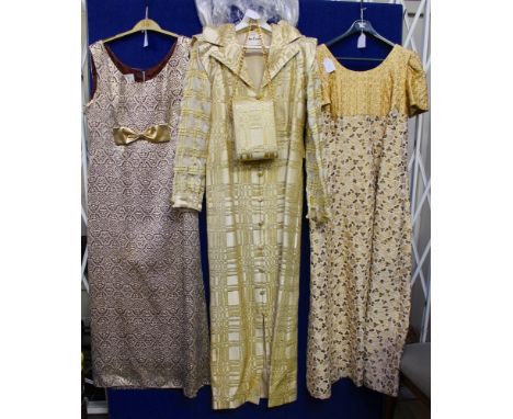 Evening and cocktail wear to include a black evening short sleeve jacket edged in gold braid, a gold evening coat in a check 