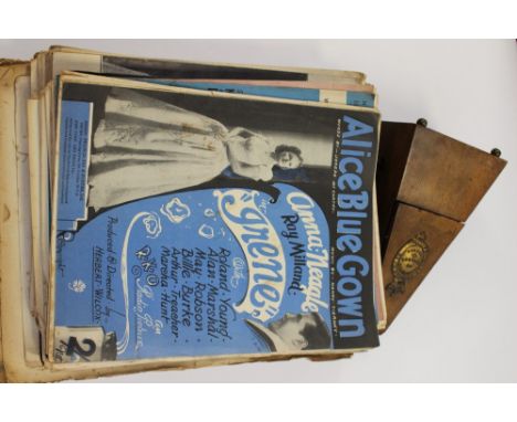 A metronome and a quantity of sheet music and book 