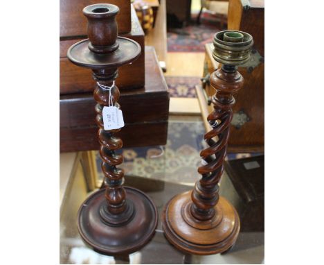 A barley twist wood candlestick, together with another similar