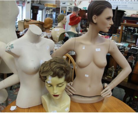 An ivory head on a shoulder base, a mannequin torso with a head and arms and another mannequin torso with no arms (counter st