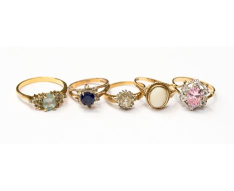 Five various dress rings, three in 9ct gold and two in gilt metal, one with opal, one with aquamarine and another with topaz,