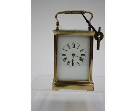 A brass carriage clock with key 