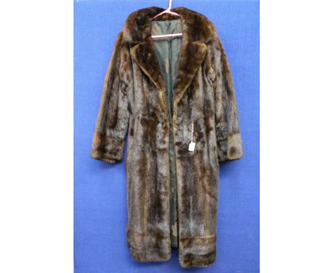 A dark brown full length Mink coat, button detail on sleeves, very interesting lining design, comprising one pocket in lining