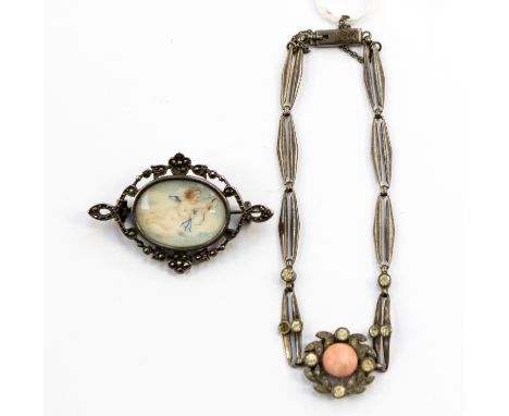An early 19th century silver brooch with a painted cherub with arrow and ribbons (faded), the openwork brooch is decorated wi