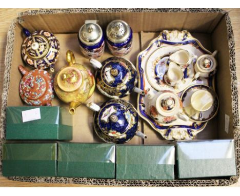 A Royal Worcester miniature teapot, decorated with fruit, together with two early Coalport and a Royal Crown Derby teapot, an