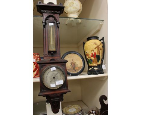 A mahogany cased barometer with mercury thermometer; together with a Bretby plaque and a Bretby style vase with Dutch figures