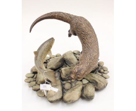 A large Neil Dalrymple 1996 ceramic sculpture, signed to base, otter and trout on rocks (1)Note: Neil Dalrymple is a renowned