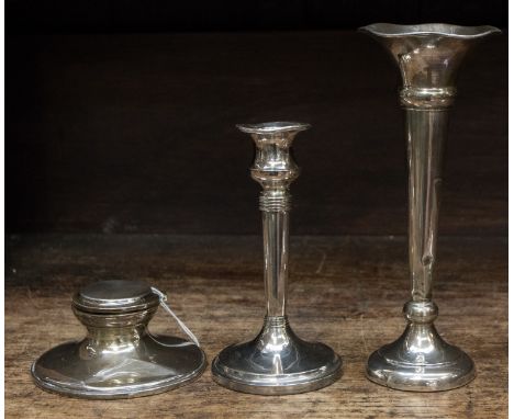 A silver capstan inkwell, trumpet vase and candlestick, all weighted, mostly rubbed hallmarks (3) 