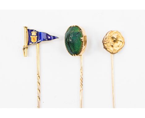 Stick pins, set in yellow and rose metal, a Scarab beetle finial, an enamel yacht dub Hag, and a Art Nouveau finial (3) boxed