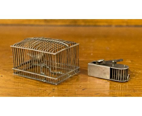 An early 20th Century white metal cigar cutter, in the form of a mouse trap; together with a model bird cage, approx dimensio