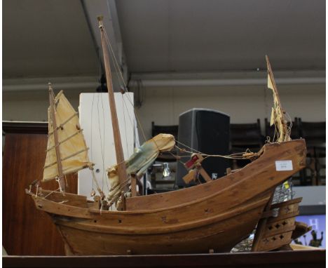 A wood model of a Chinese Junk; together with a Black Forest tray and a turned wood candlestick (3) 