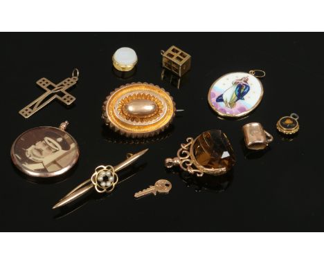A box of assorted gold jewellery oddments including cross pendant, swivel citrine fob, photo locket and oval enamel religious