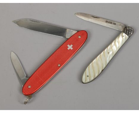 A silver fruit knife with carved mother of pearl scales, assayed Birmingham 1890, along with a Victorinox pen knife.