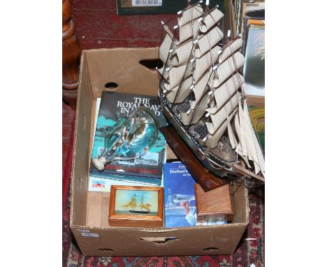 A collection of nautical themed items to include model ship 'Cutty Sark' ship in a bottle, books, compass etc.