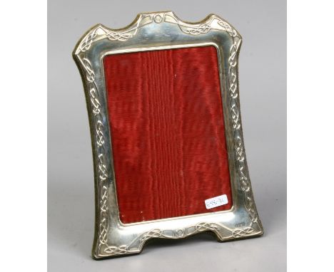 A silver eizel photograph frame embossed with Celtic style borders, assayed Sheffield 1996, 25cm.