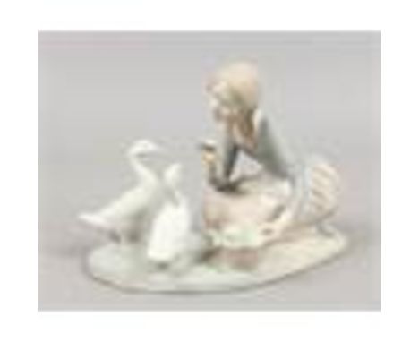 A bisque Lladro figure feeding the ducks.